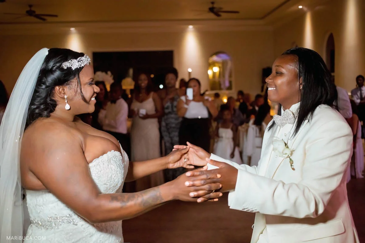 The groom and the bride look each other in the first dance wedding. Same sex wedding.