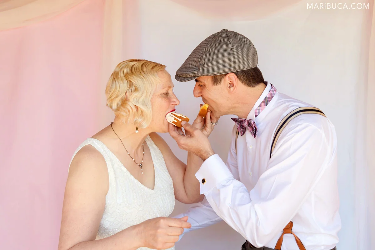 Bride and groom feed each other after cutting their first wedding cake