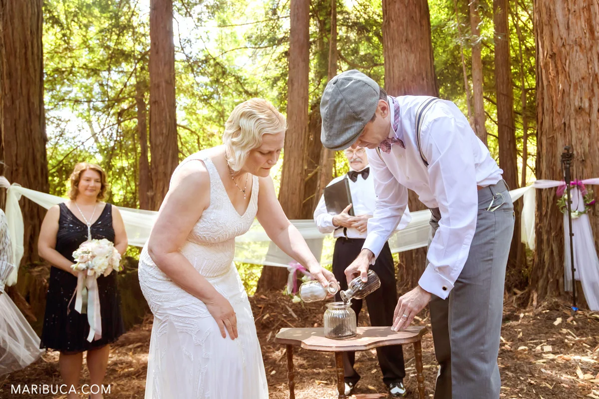 The bride and the groom are doing the sand ceremony in the wedding, Saratoga Springs.