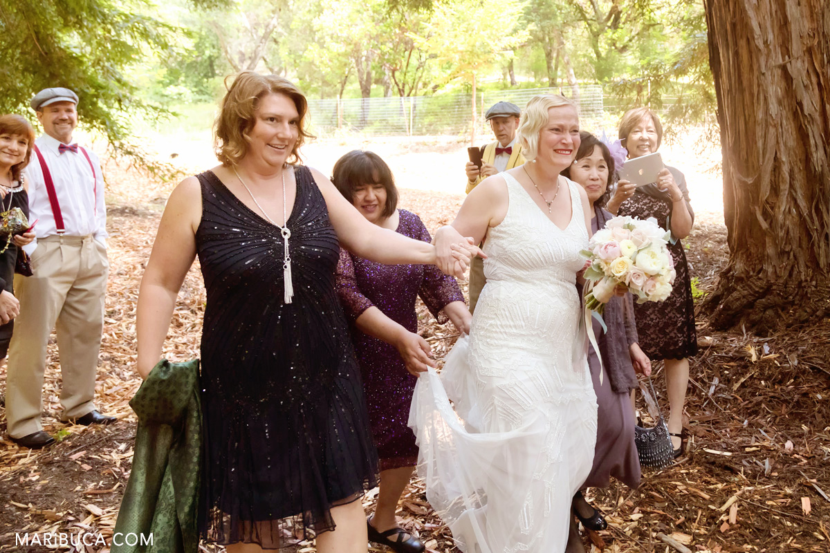 The bride comes down the aisle, and cries with happiness in the wedding day.