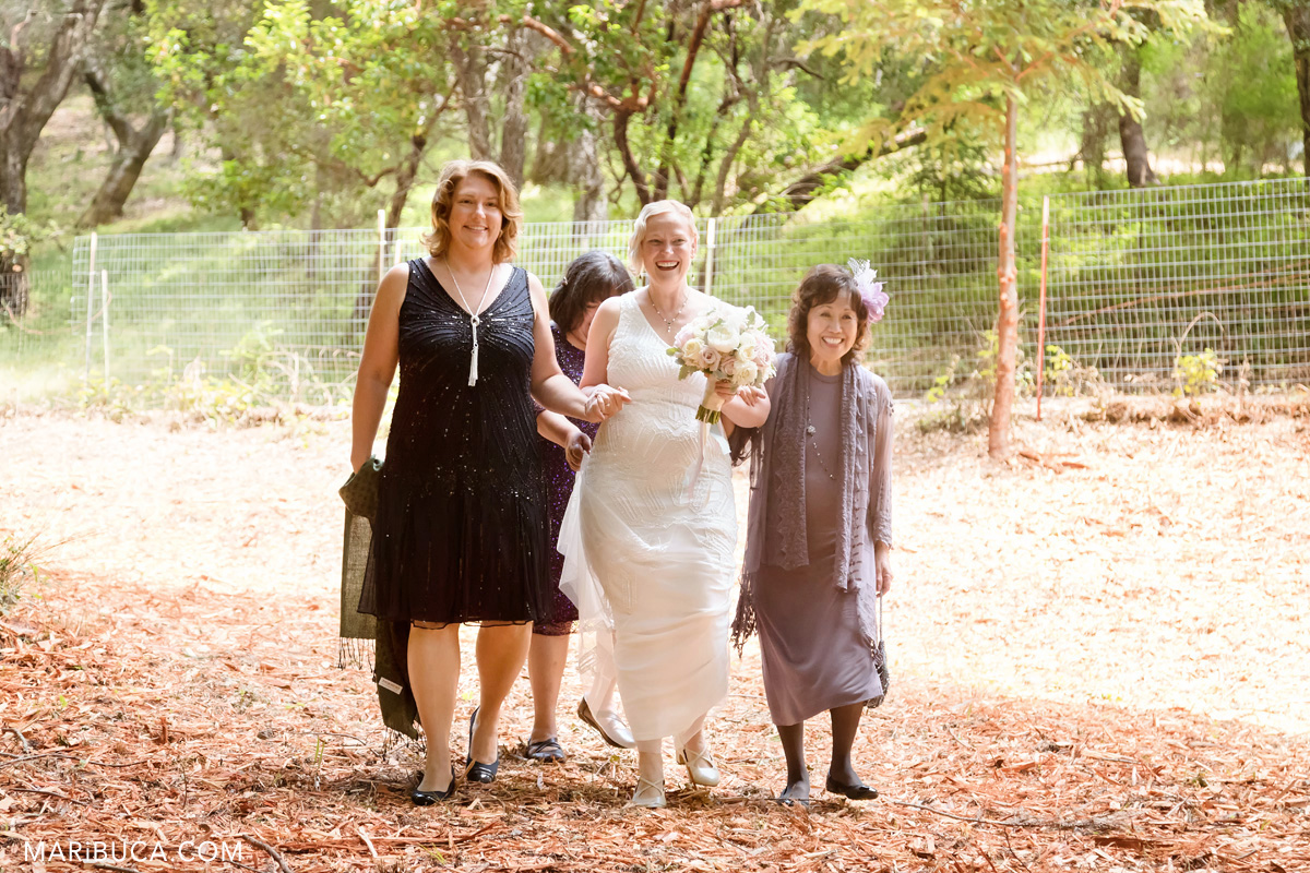 The bride with bridesmaids go down the aisle in the Los Gatos wedding. .