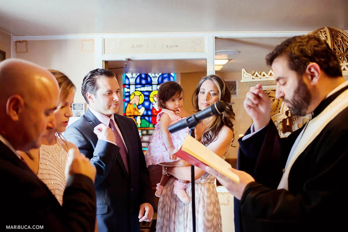 Family and friends in the St Nicholas church in the San Jose during christian baptism