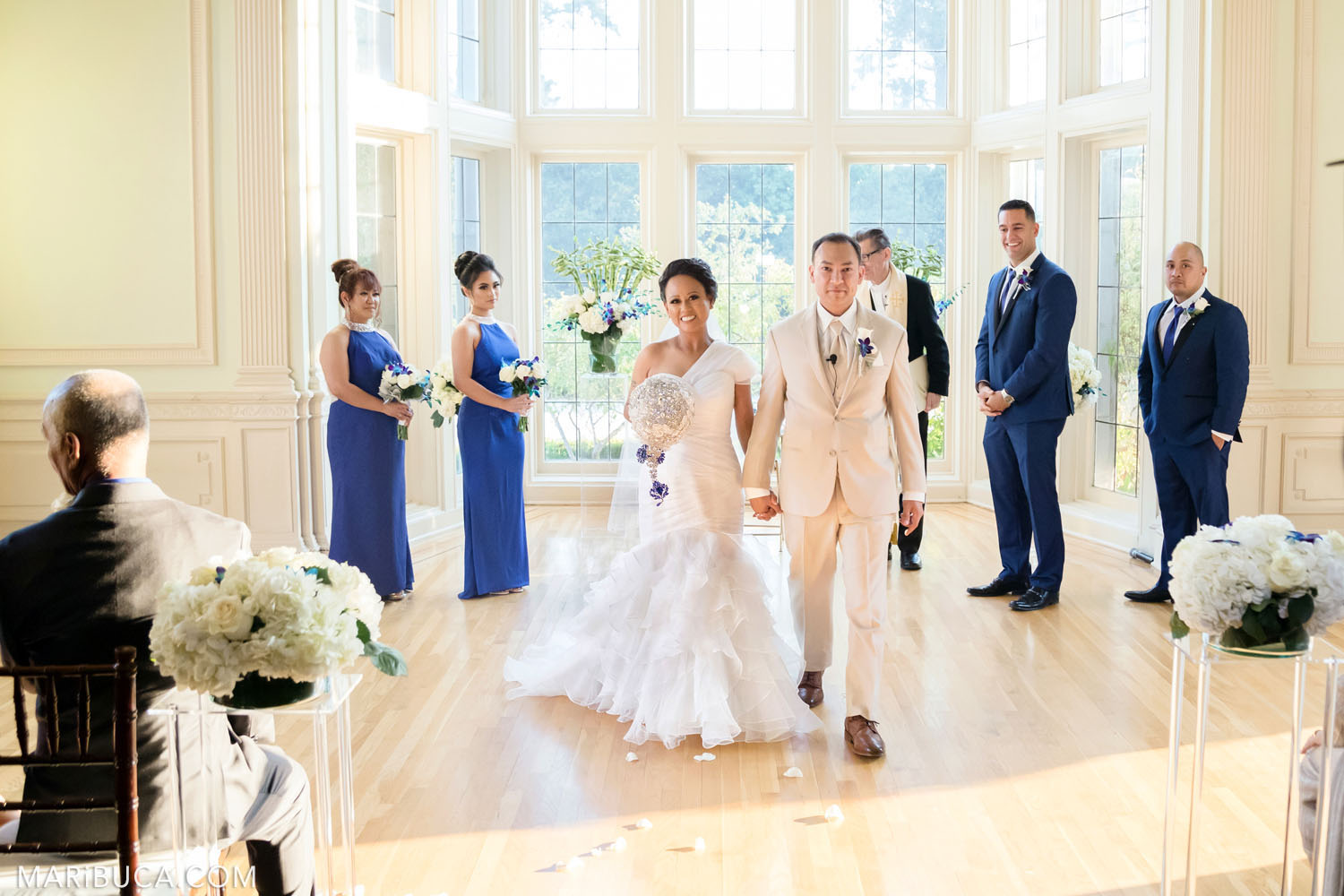 The bride and the groom are leaving the wedding ceremony in the Dining room, Kohl Mansion Wedding, Burlingame.