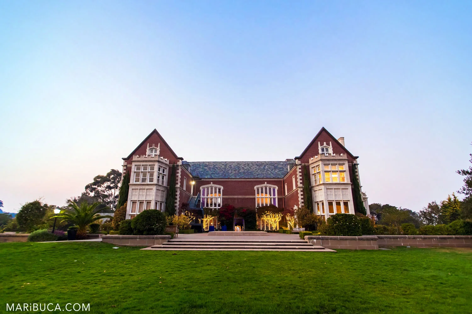 Kohl Mansion building during the night time with lights and blue sky.