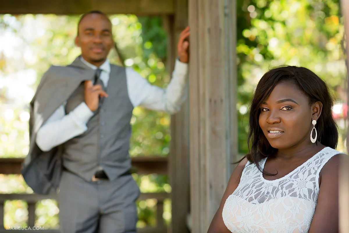 The bride stands in front of her handsome groom in the Hayward Japanese Garden.
