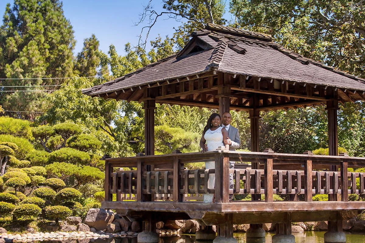 Newlyweds are staying in the gazebo during hot summer time in the Hayward Japanese Garden.