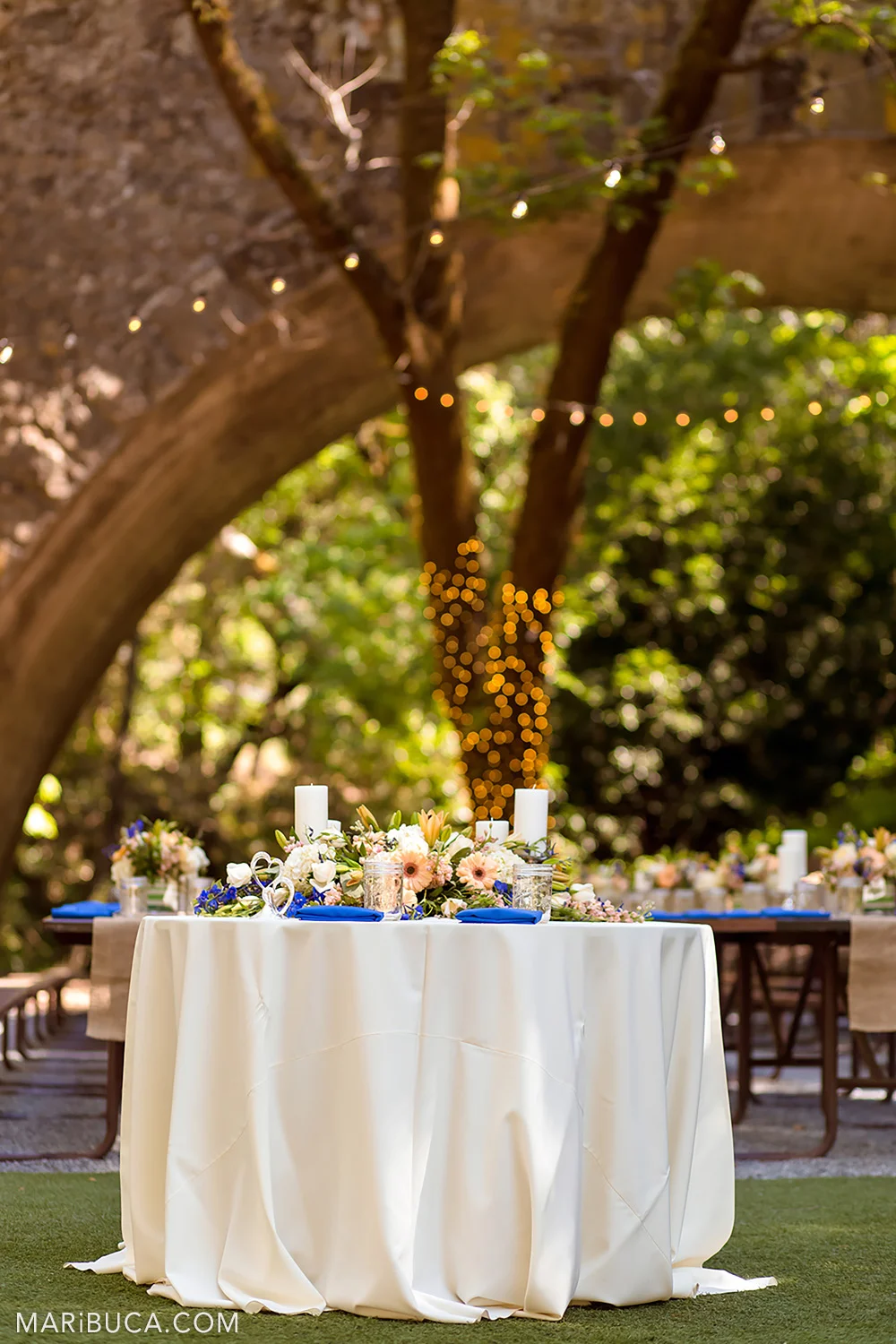 Wedding table decorations surrounded the guests tables and orange light element in the background in the Saratoga Springs Venue