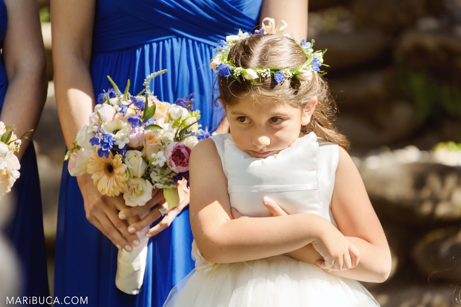 The flower girl hugs the white wedding pillow during the wedding ceremony in the in the Saratoga Springs Wedding