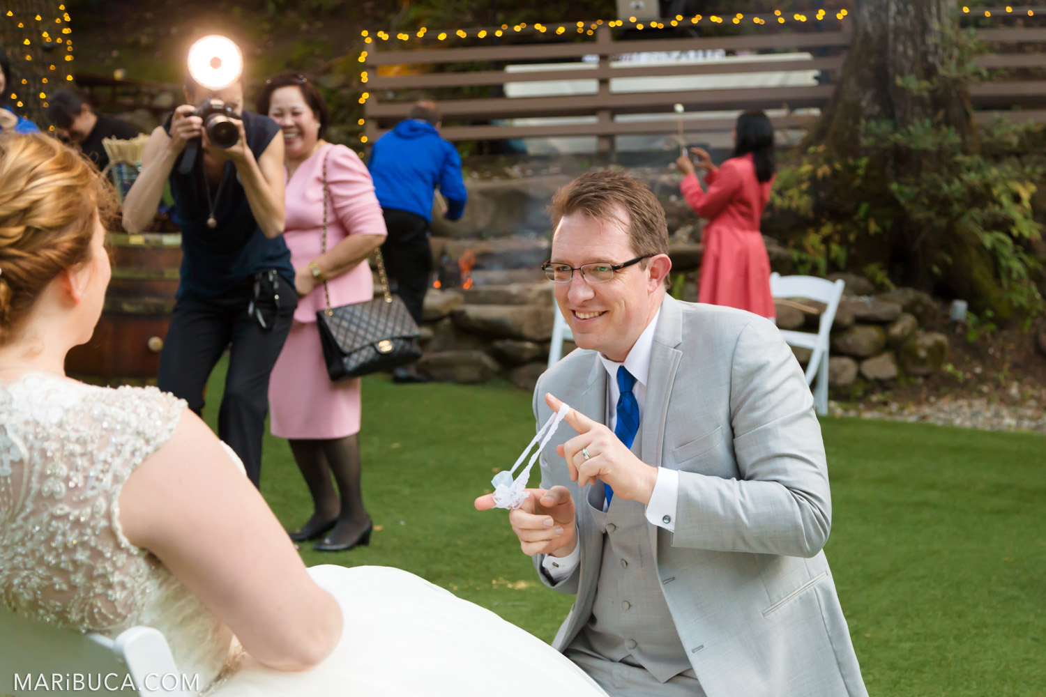 The groom shows bride’s garter in the Saratoga Springs Wedding