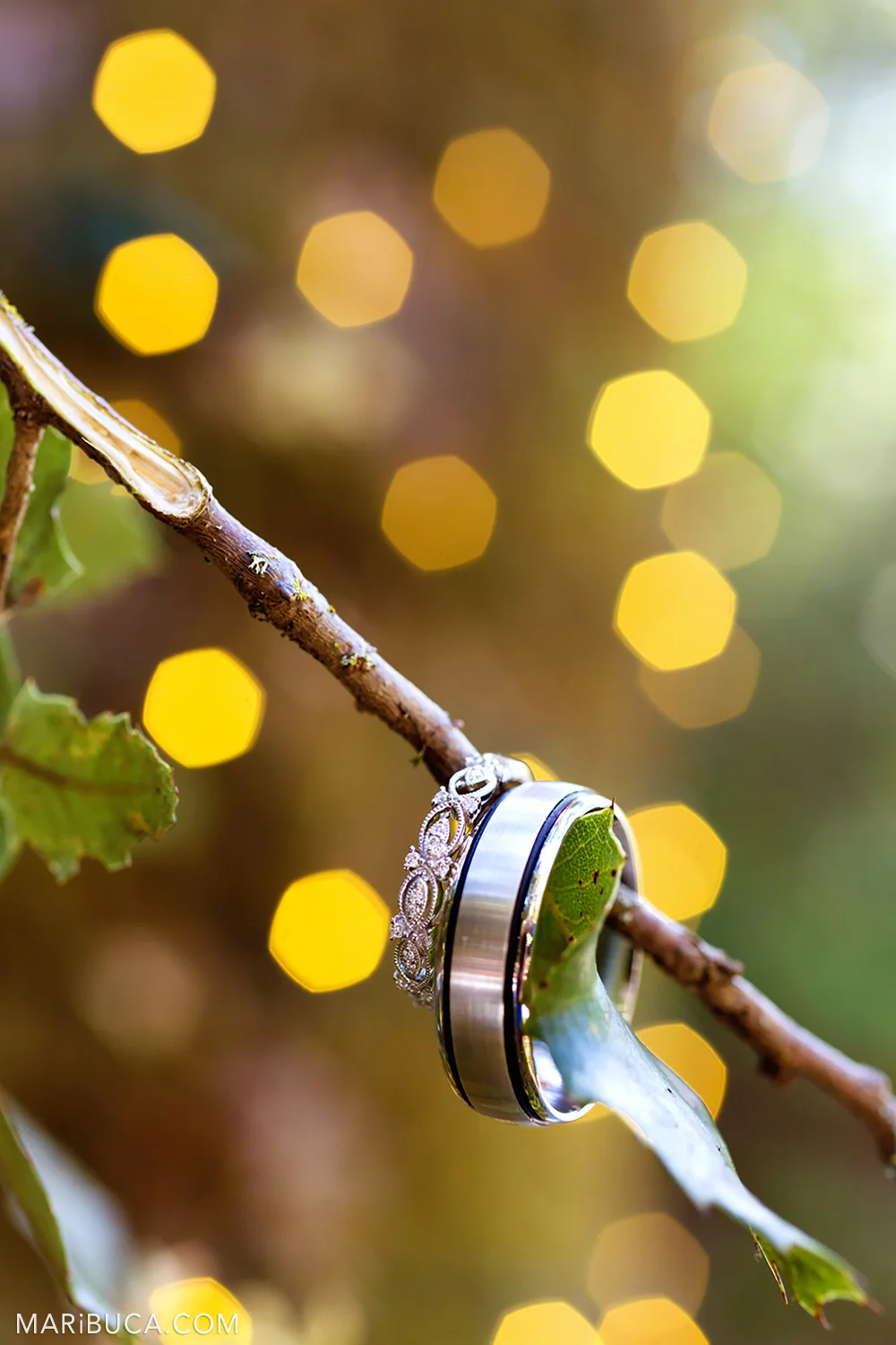 Wedding rings and yellow bokeh as background in the Saratoga Springs Wedding