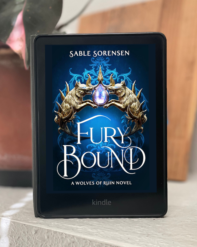 My Kindle sits on a white ledge with the cover of Fury Bound by Sable Sorensen.