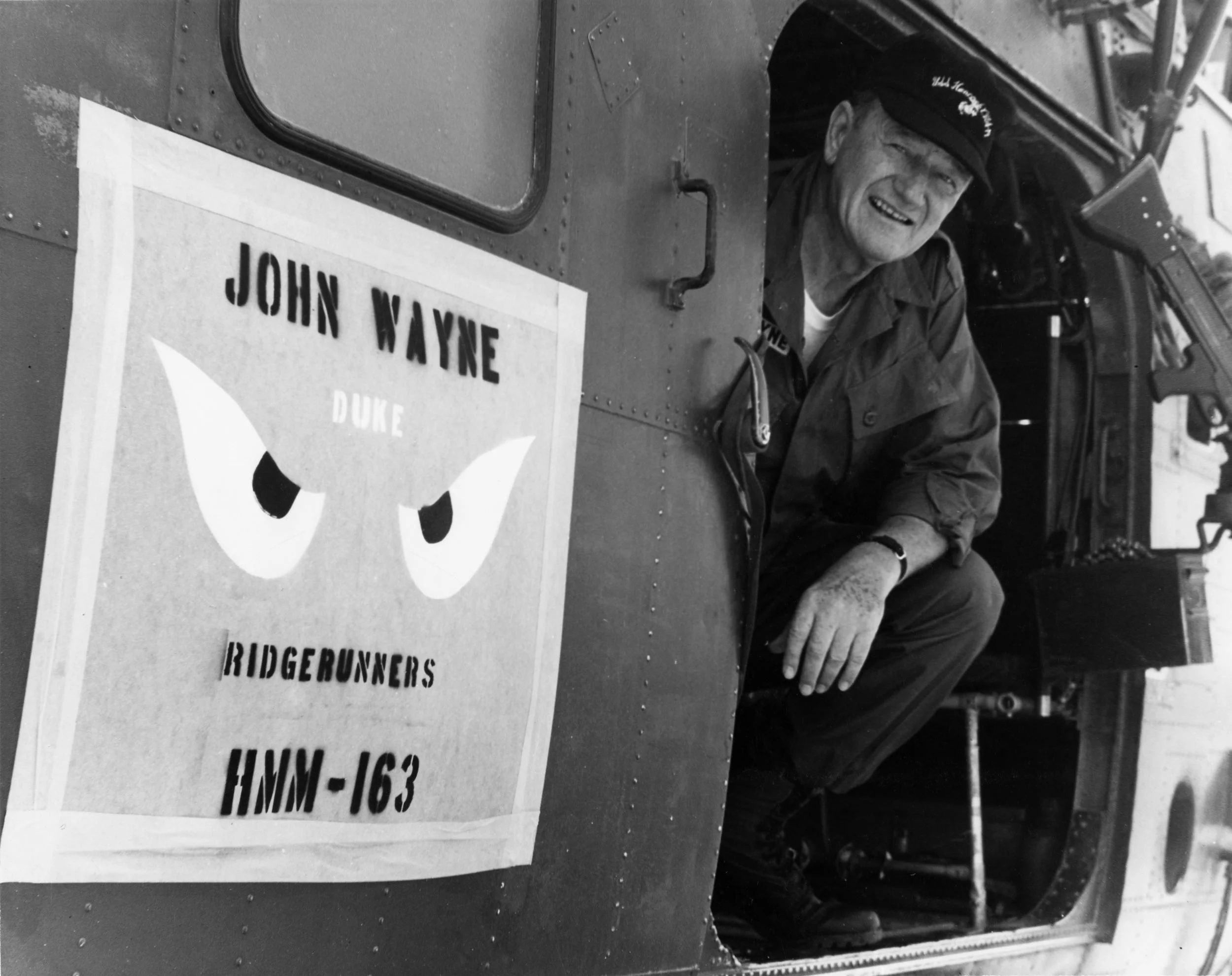 John Wayne aboard the Medium Lift Tiltrotor Squadron HMM-163 while visiting the troops in Vietnam in 1966. The aircraft was commandeered by the US Marine Corps helicopter squadron known as the “Ridge Runner’s”. The HMM-163 featured painted "Genie Eyes" after the "I Dream of Jeannie" TV show on the side of the helicopter. Photo courtesy of CPL. L. L. Atherton