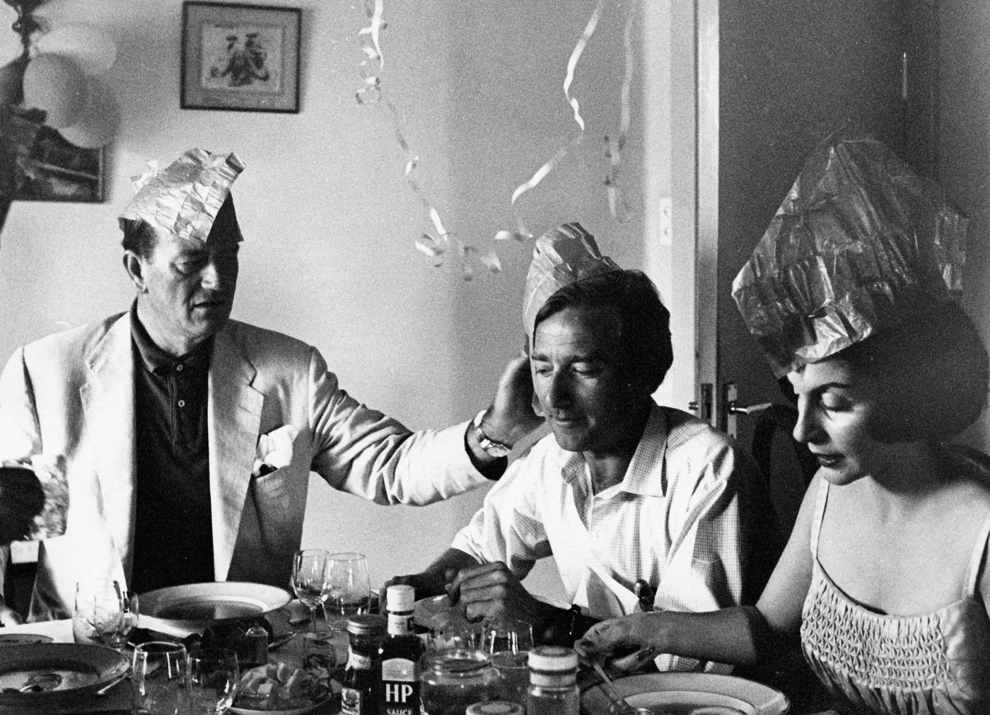 John Wayne and Pilar Wayne enjoying a celebratory dinner with friends in Africa. Photo courtesy of John Wayne Enterprises
