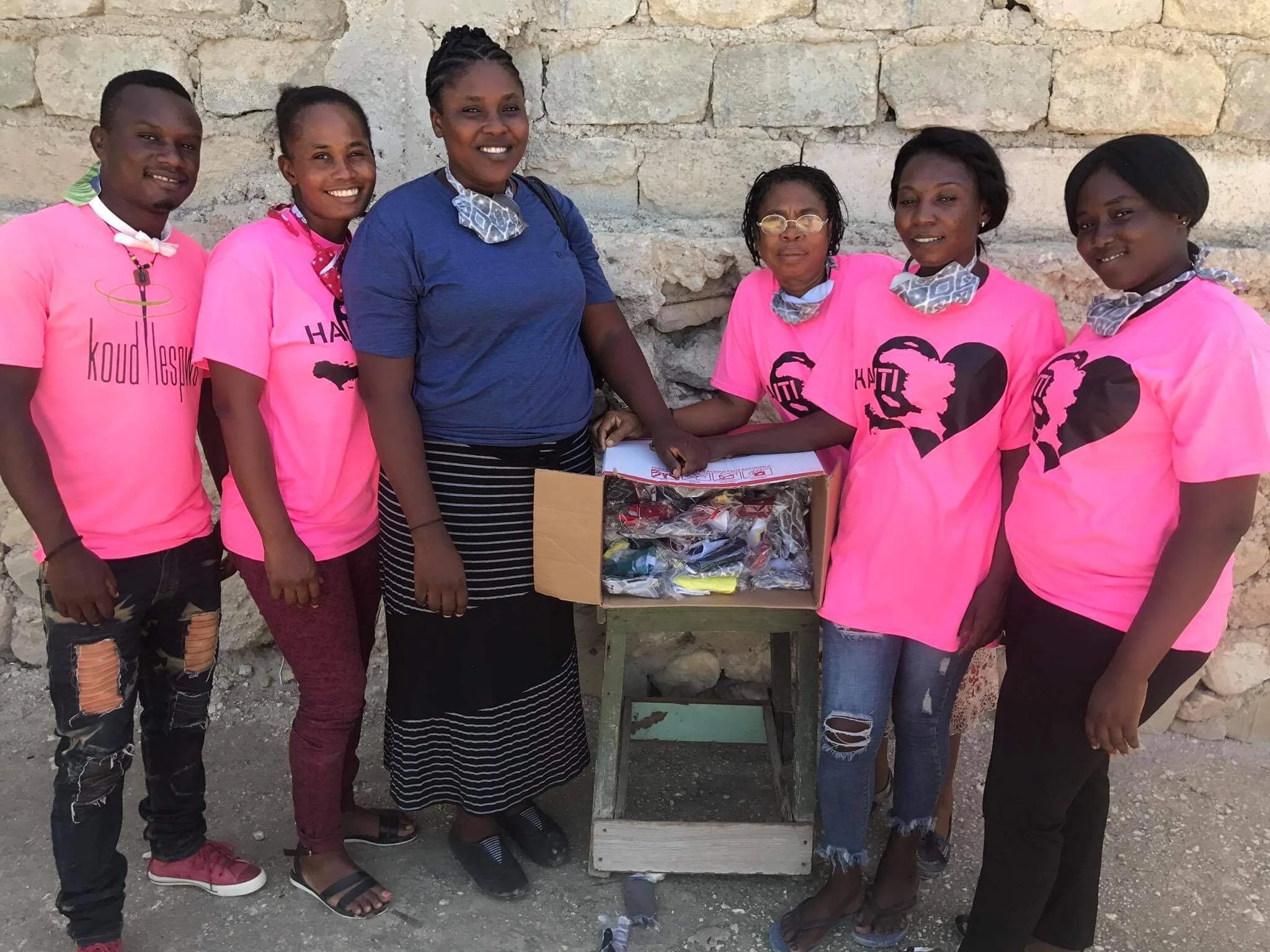  Hope Sewn ladies handing out masks to school children 