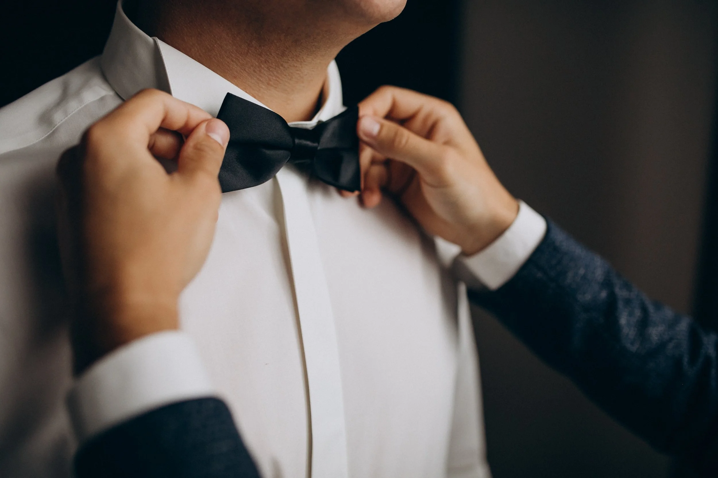 groom-dressing-before-wedding-ceremony-putting-bow.jpg