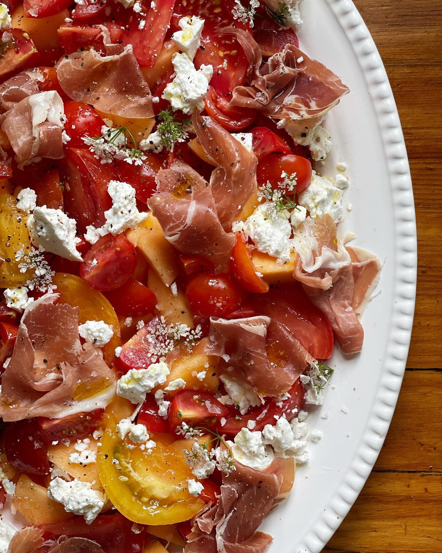 Tomatoes / cantaloupe / prosciutto / feta / cilantro flowers / @wearebrightland