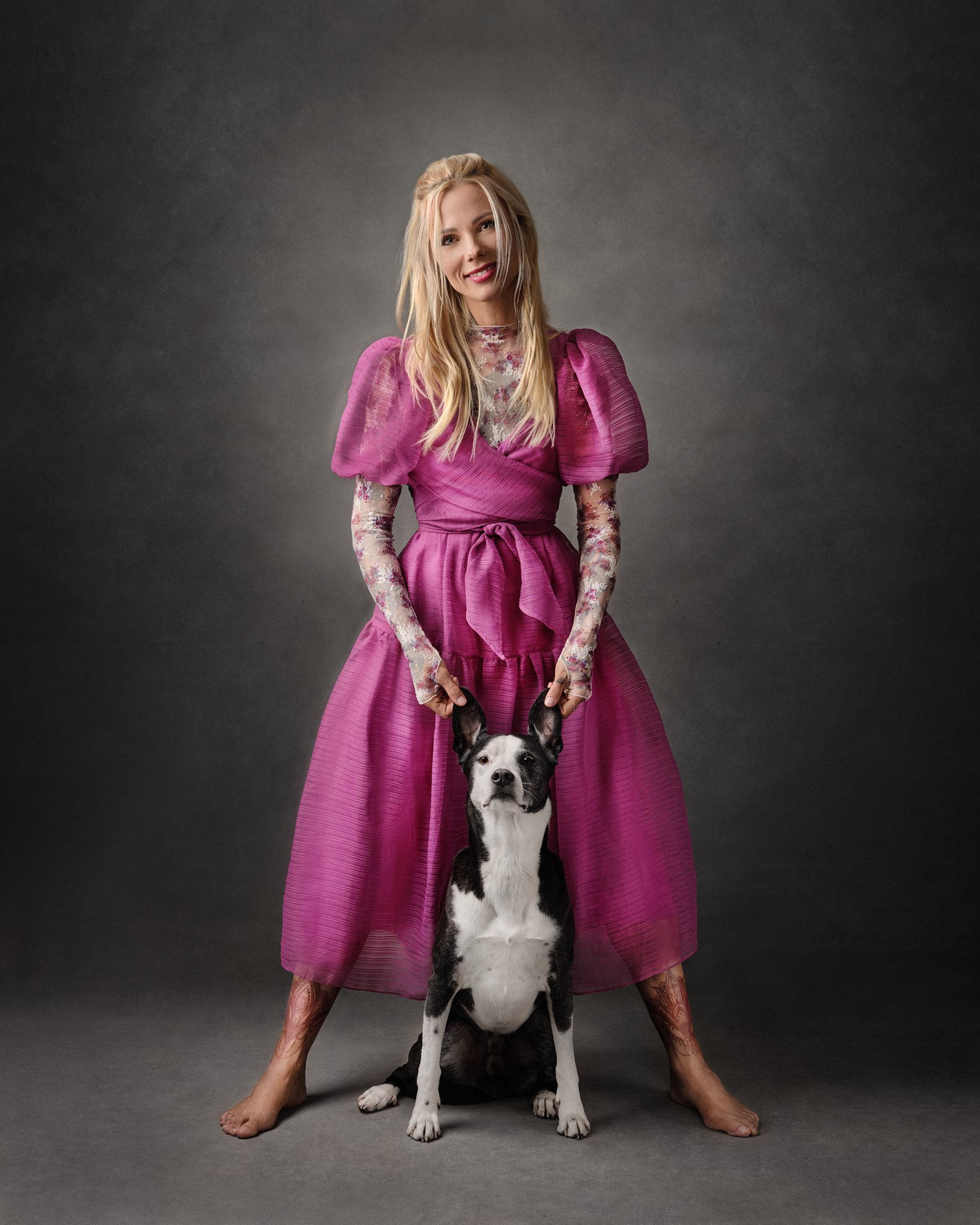 blonde-woman-with-black-and-white-dog-portrait-standing-with-pink-dress.jpg