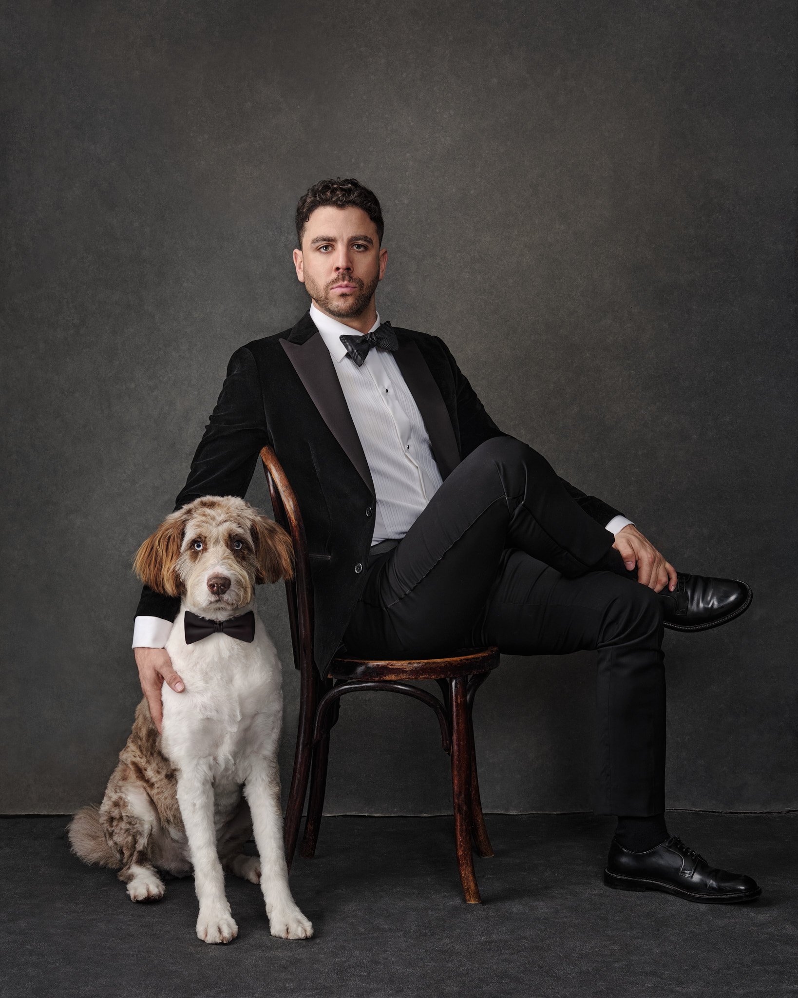 Man-with-dog-wearing-tuxedos-studio-portrait.jpg