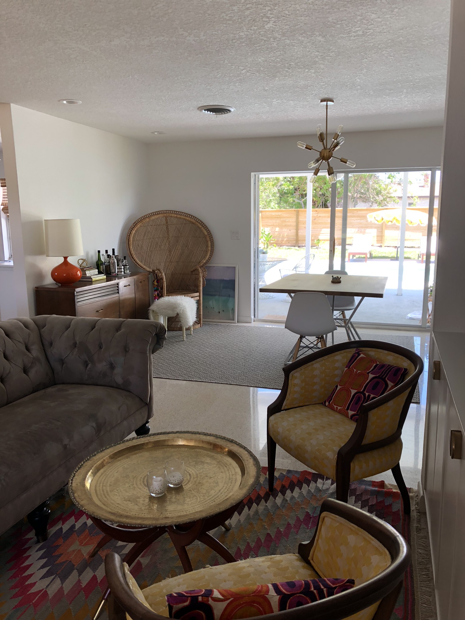  looking straight out through living area, to dining, to the pool area, from the front entry. 