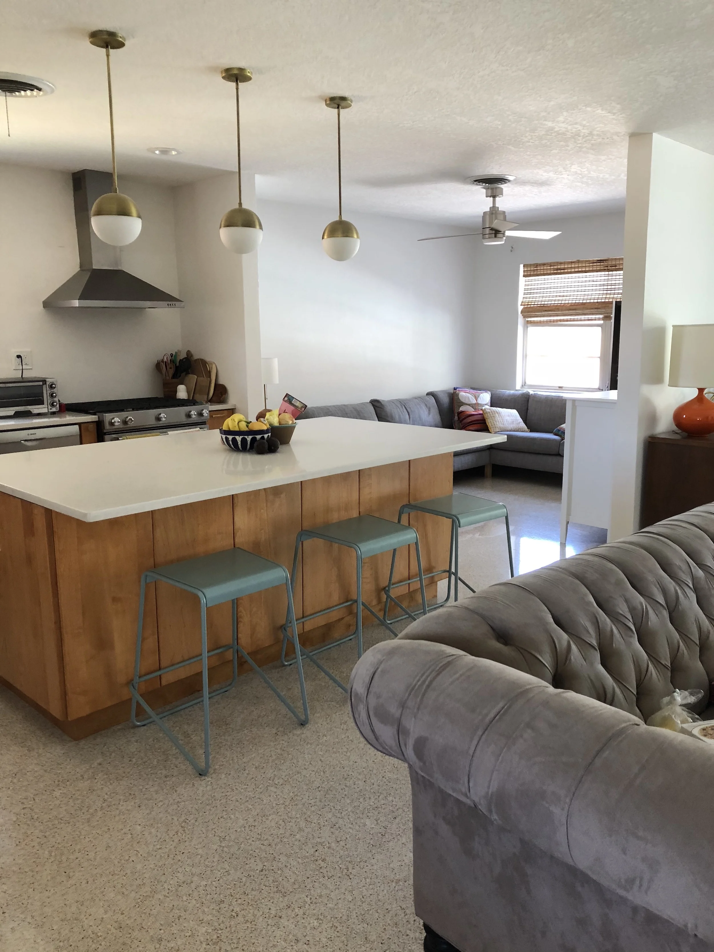  Where the kitchen wall once stood, now there is an island opening to the rest of the house. 