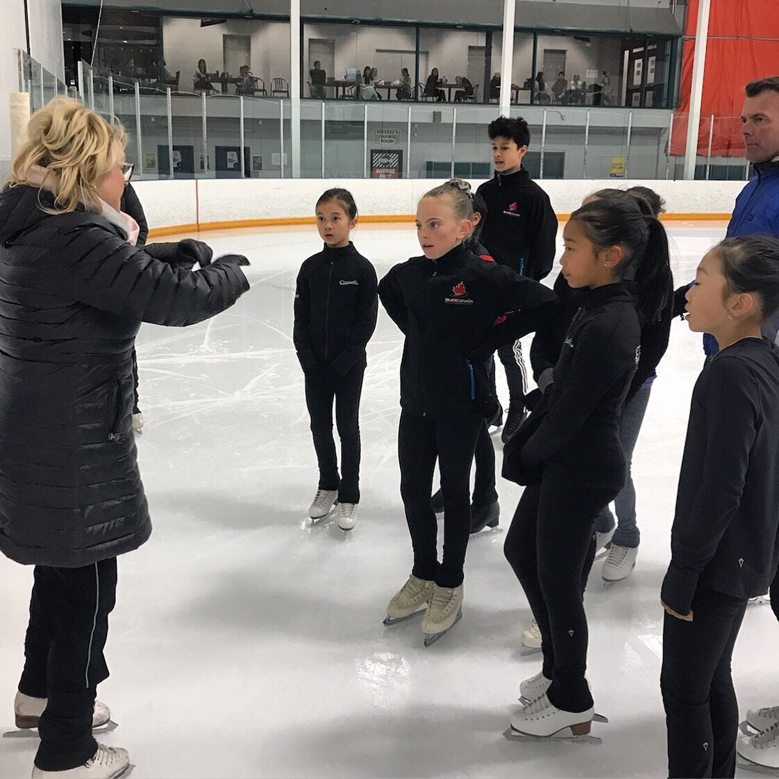  Joanne with Scott Davis working with BC Team skaters at the BC Team Development camp 
