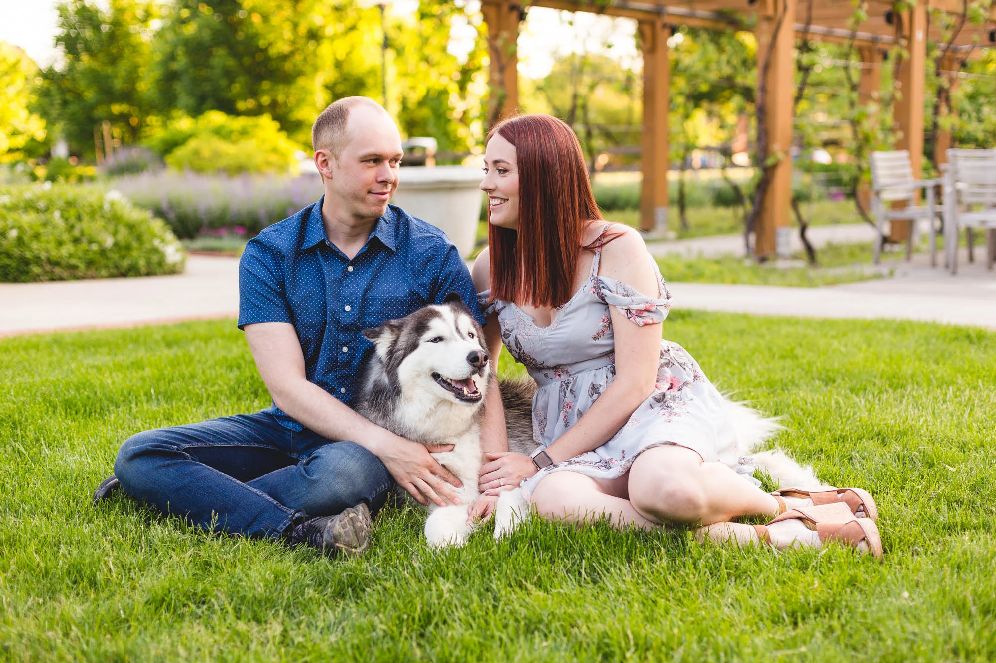 couple posing with husky dog at franklin park conservatory for engagement photos