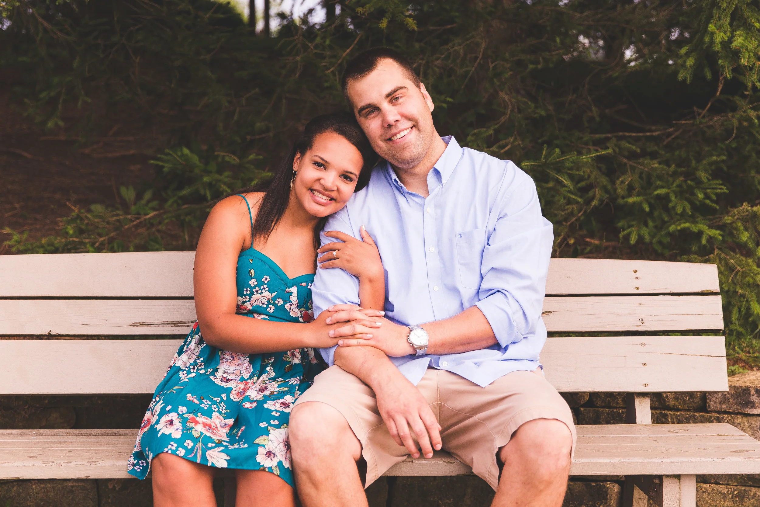 Scott and Shaytell pose on a bench at Homestead Park in Hilliard Ohio during their engagement session