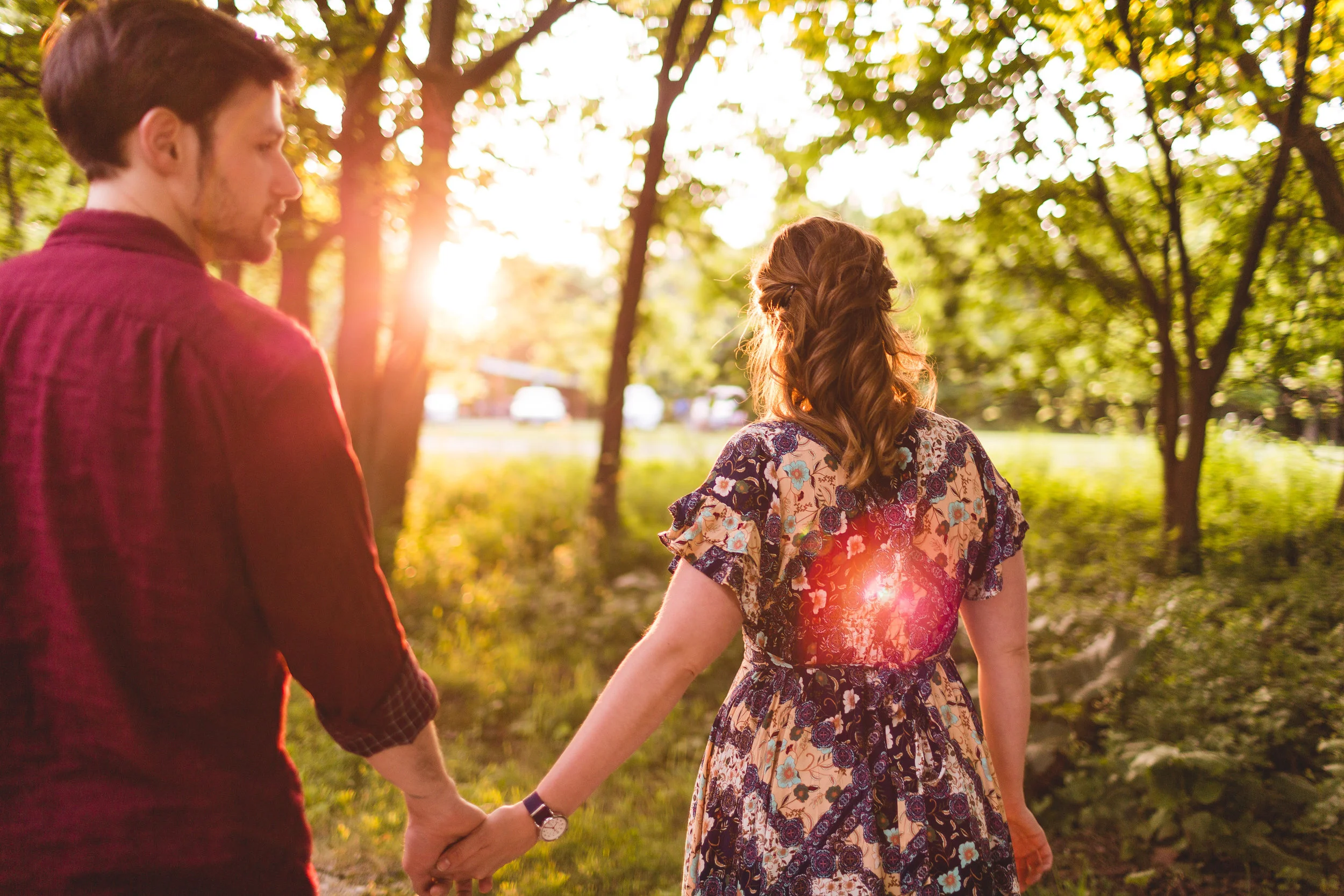 woman walks fiancé through woods during sunset in Pickerington Ponds Park in Ohio