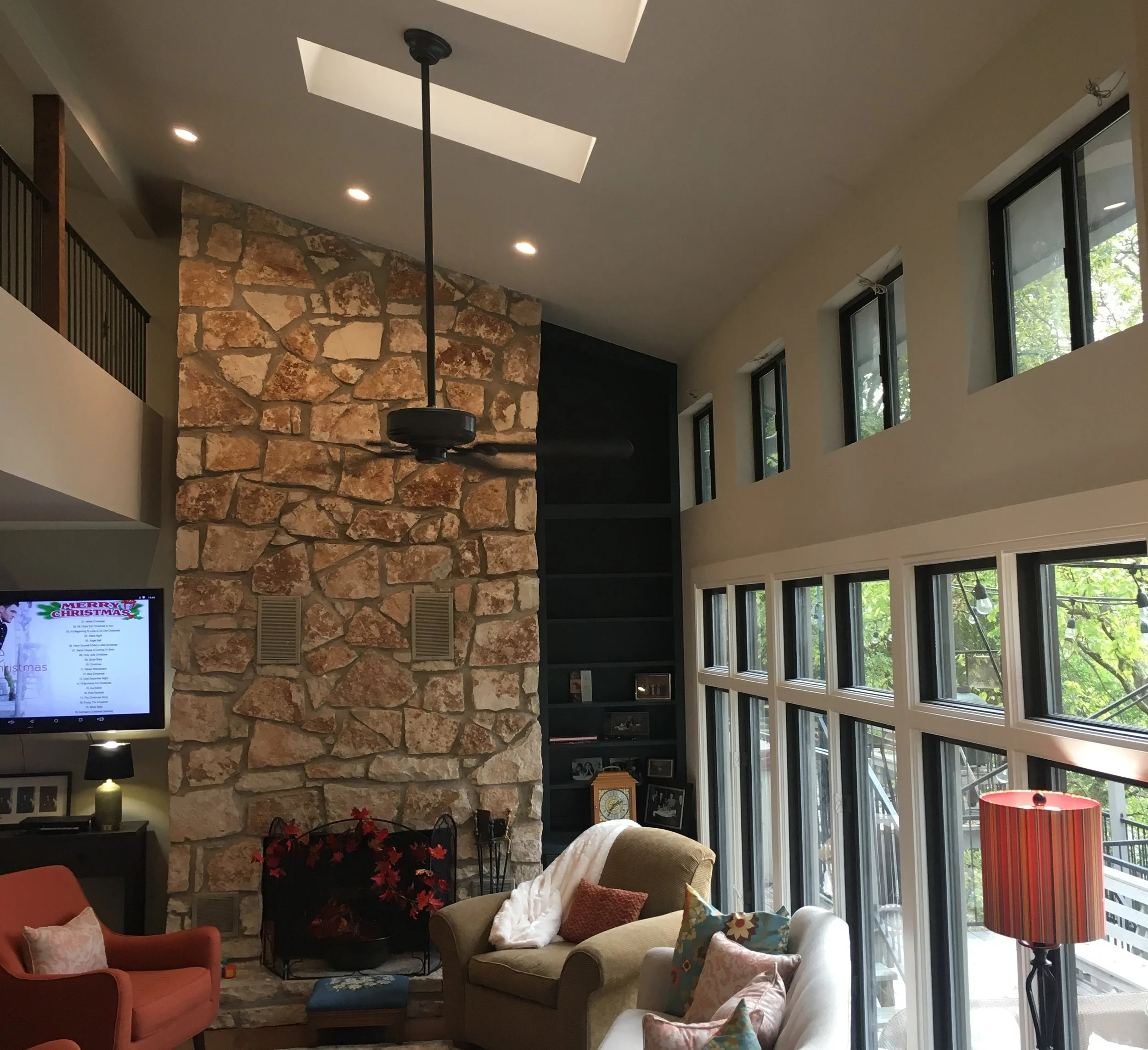 Custom built-in bookcases flanking stone fireplace in Austin, Texas.
