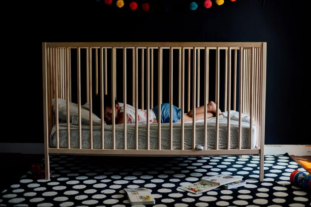 A baby in her crib. Families in St. Louis looking for a postpartum doula near me can contact Robbins Doula Services.