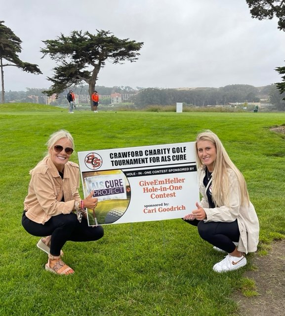  Lesley and Lauren Heller hold the 'Give Em Heller' Hole-in-One Sign 