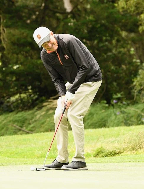 Giants President CEO Larry Baer lines up a putt