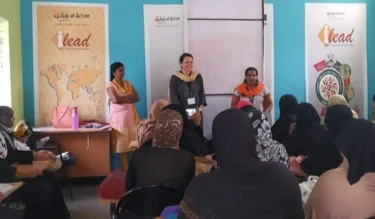 Amand, a nurse, teaching about hand hygiene, breast and cervical cancer, and self-examinations for breast cancer.
