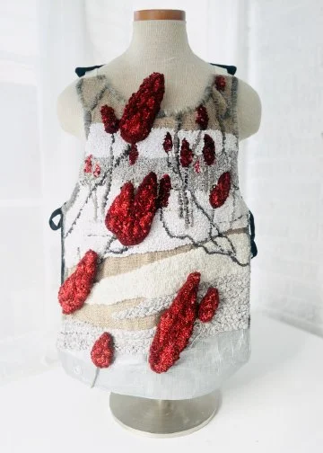 Red Sumac Vest, 2025, camping tarpaulin fabric, yarn, re-purposed textiles, metallic sheen textiles, beads. Techniques: Hand hooked, hand beaded, machine and hand sewn.