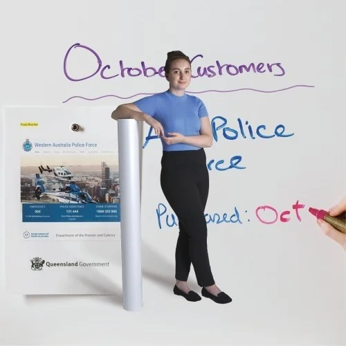 woman-leaning-against-roll-of-smart-magnetic-whiteboard-wallpaper-low-sheen.jpg