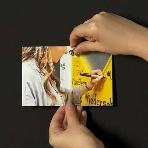 images-being-stuck-up-on-magnetic-wall-in-office-by-woman.jpg