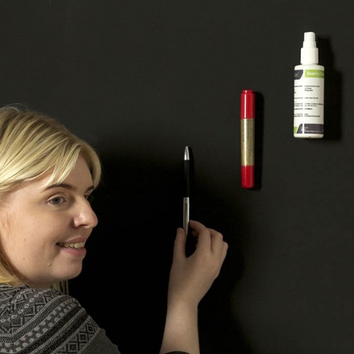 woman-sticking-up-items-on_super-magnetic-paint.jpg