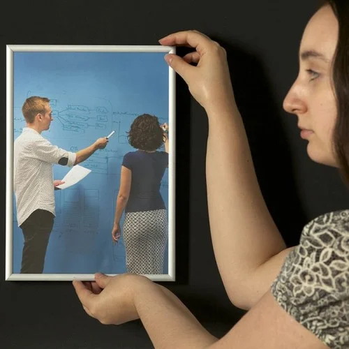 woman-hanging-up-frame-on-super-magnetic-paint-coated-wall.jpg
