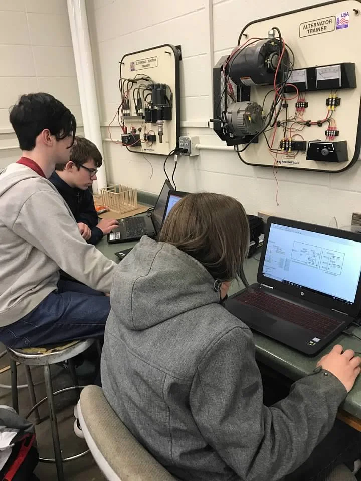 Programming students John, Ethan, and Jacob hard at work in Labview!