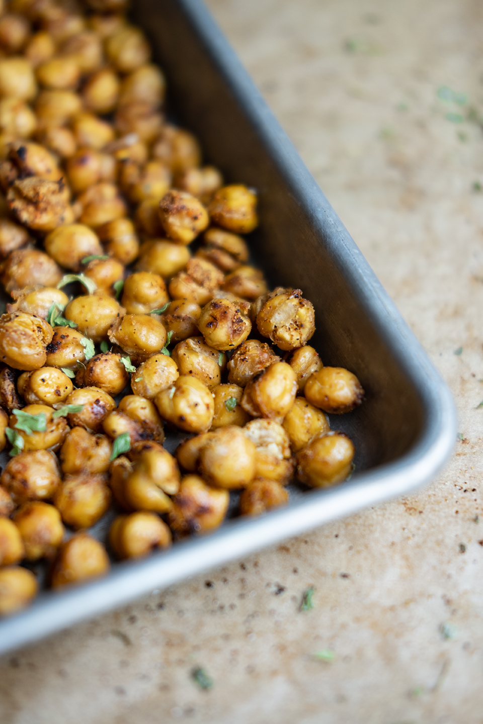  Spicy roasted chickpeas on a metal tray. 