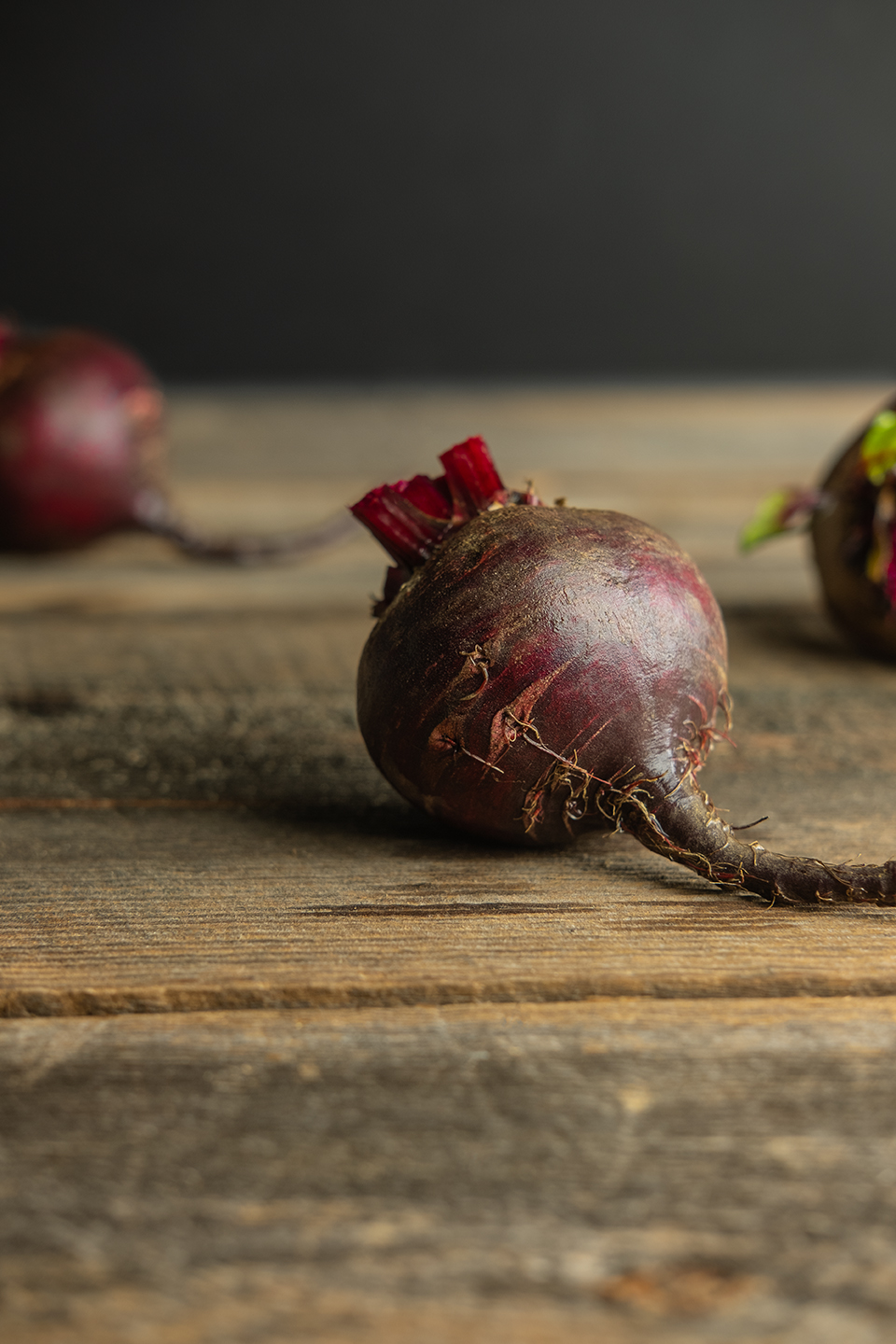  Washed raw red beet on a rustic barnwood background.  