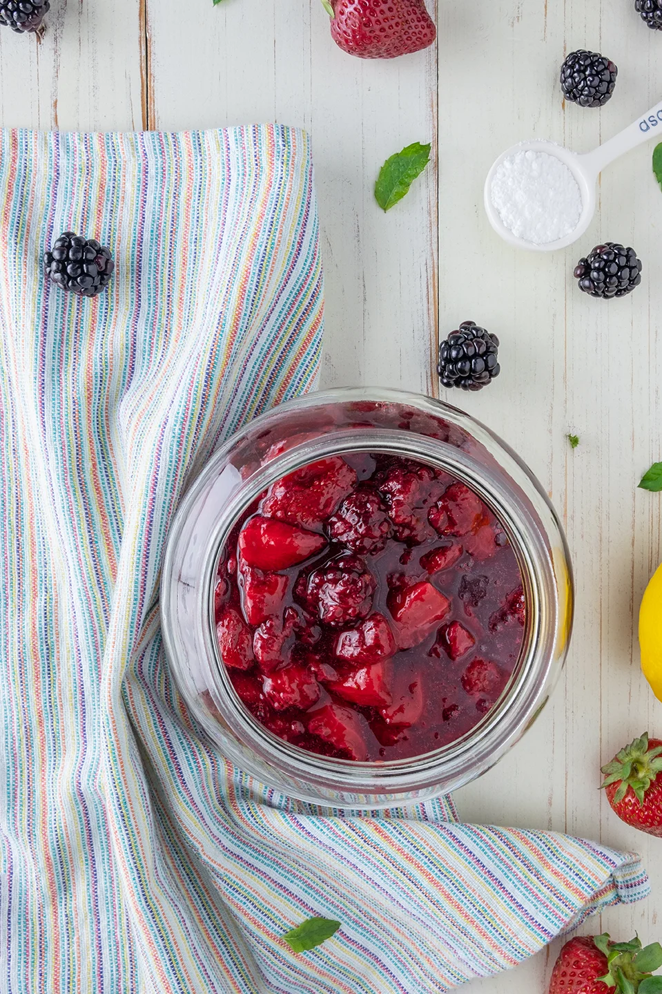  Glass jar with berry compote.  Stripped napkin.  