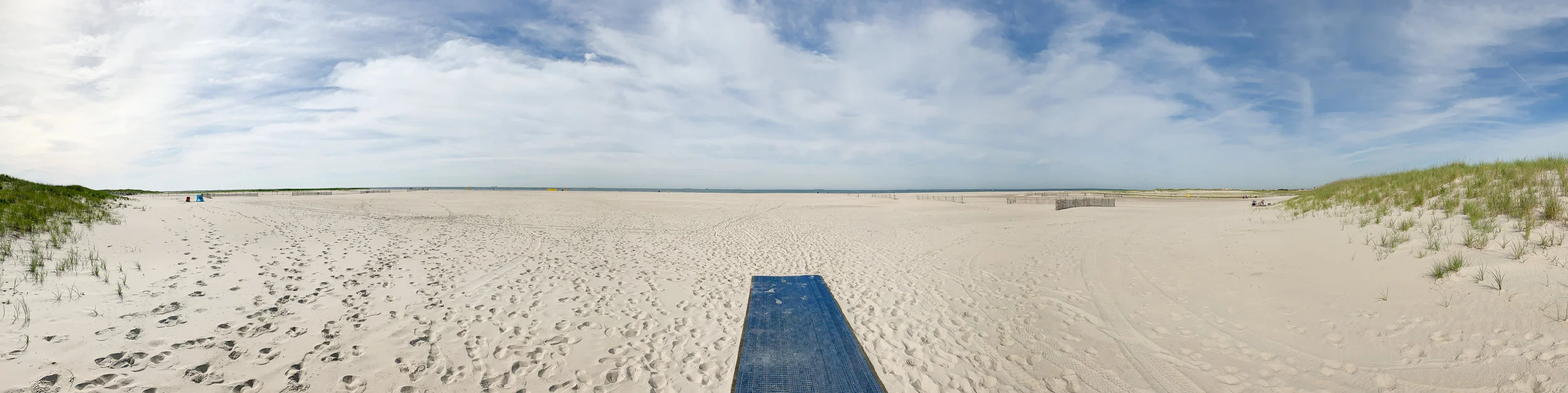View of the beach from the main entrance. Area A (East Colony) is located on the left, Area B (West Colony) is on the right. Note the ending of the blue mat. From this point, you are walking on the sand.