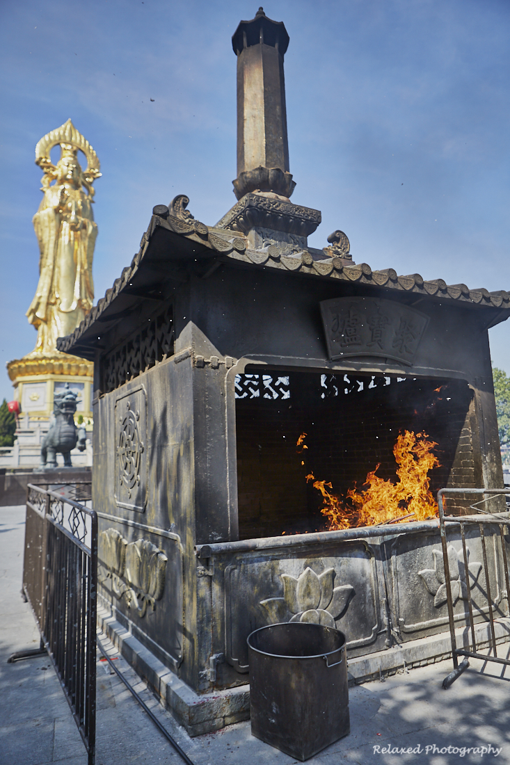 Placed around the statue are a series of ornate fire pits. These are used for burning the paper symbols that most worshippers bring. An example of these is shown in the following image.