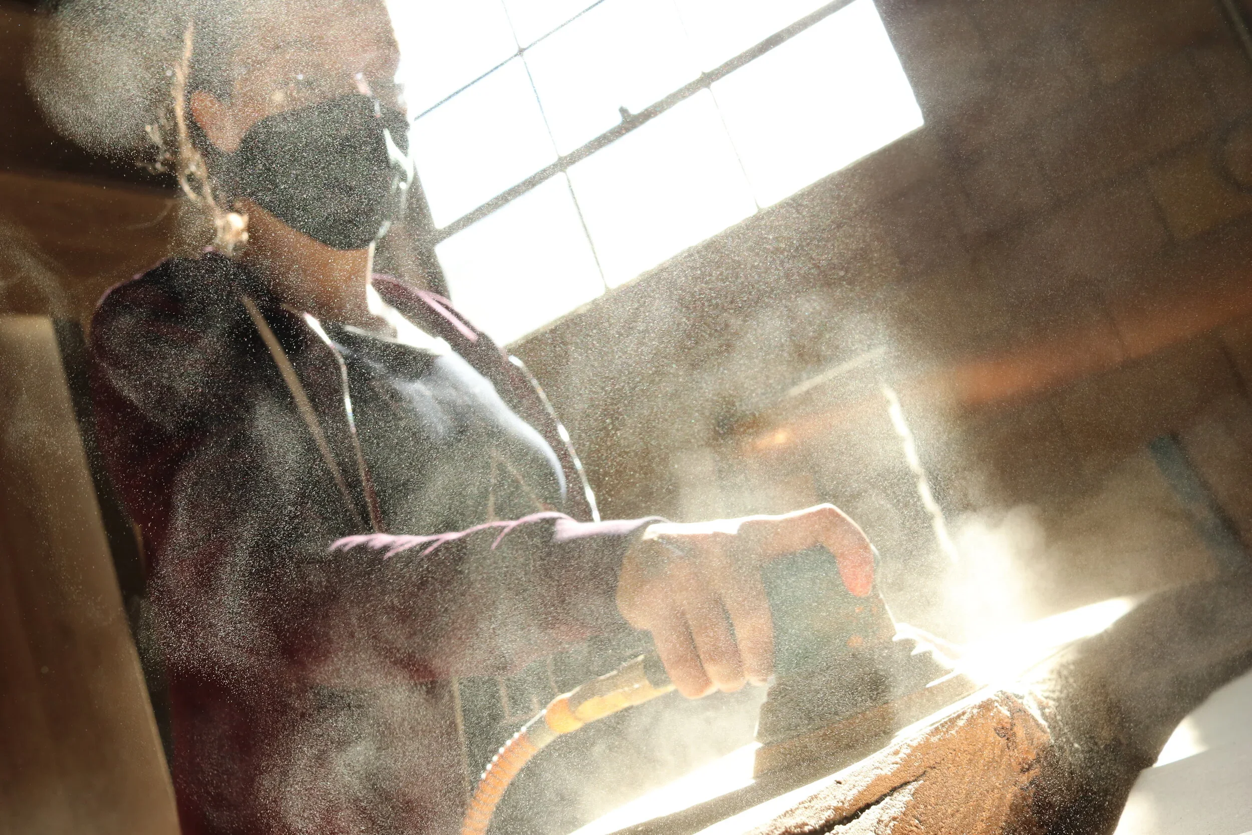 sanding+wood+in+preparation+for+wood+burning.webp