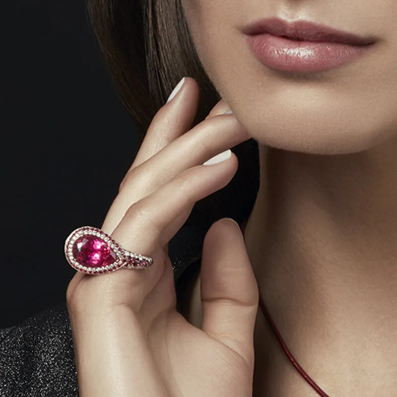 Model wearing Luxury Cocktail Ring in 18 Karat Gold Diamonds Rubies and Rubelites