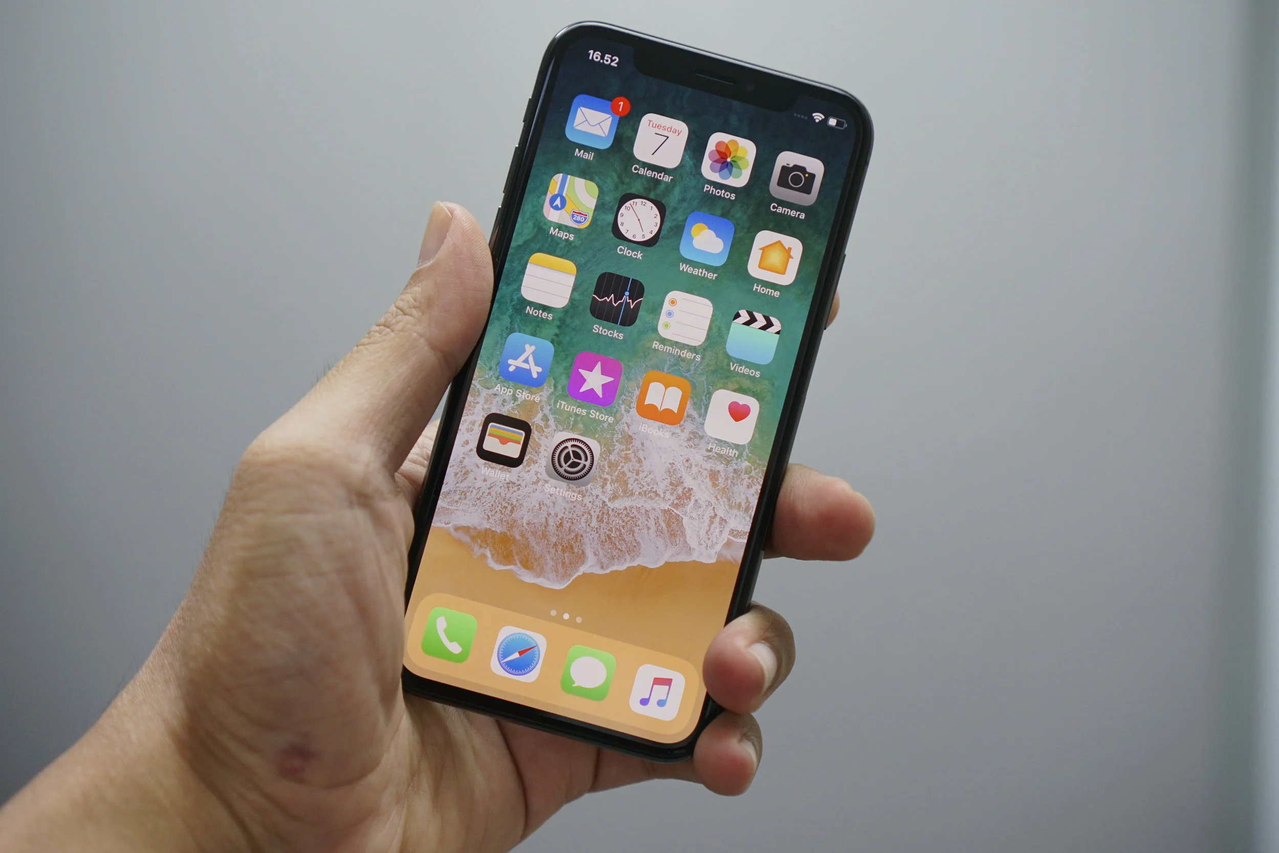 A man holding an Apple iPhone