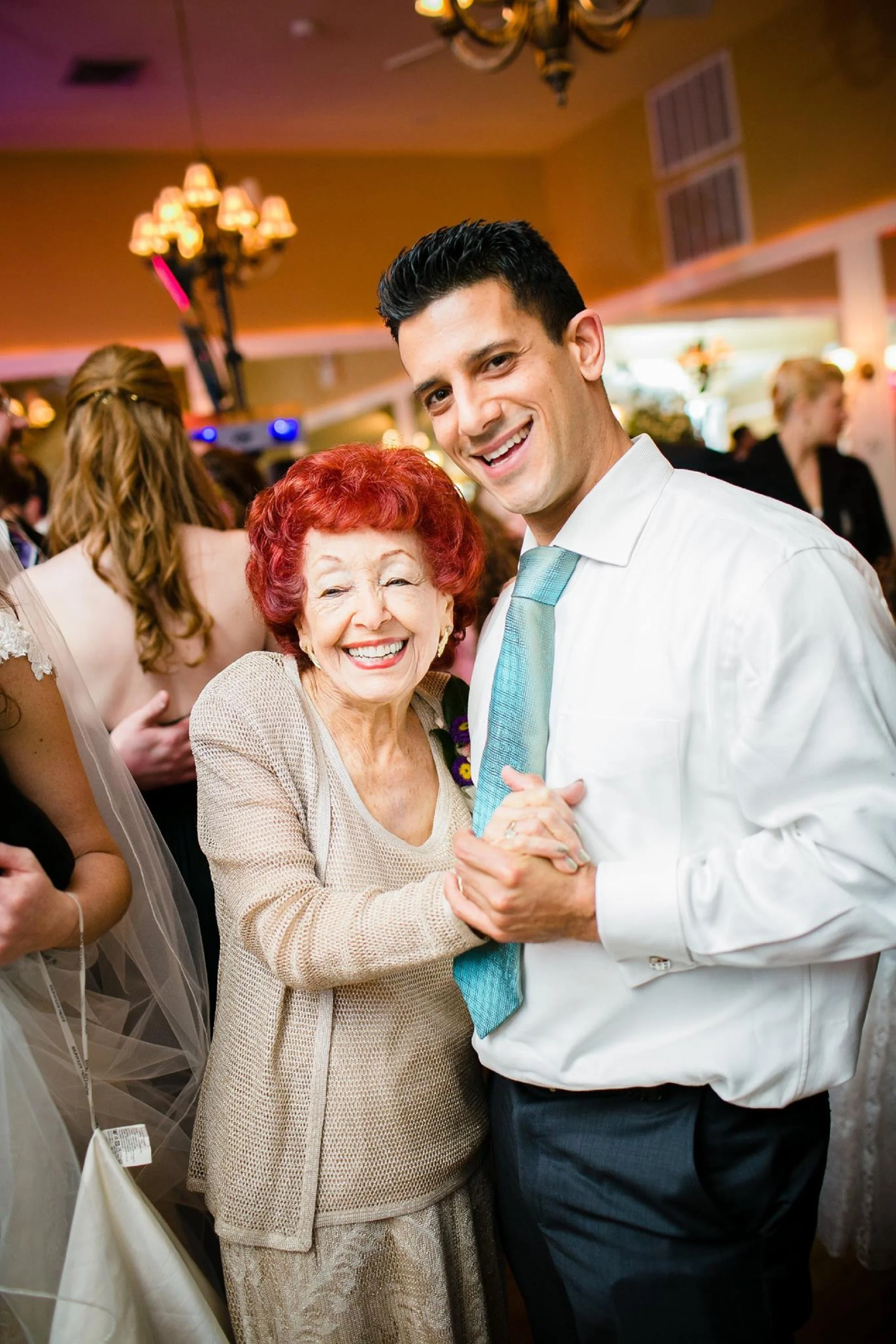 An older woman and younger man dancing at a wedding