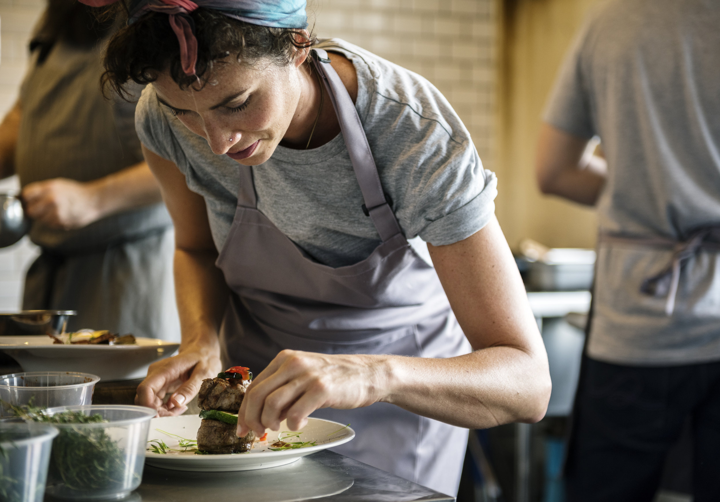 woman with apron plating food.jpg