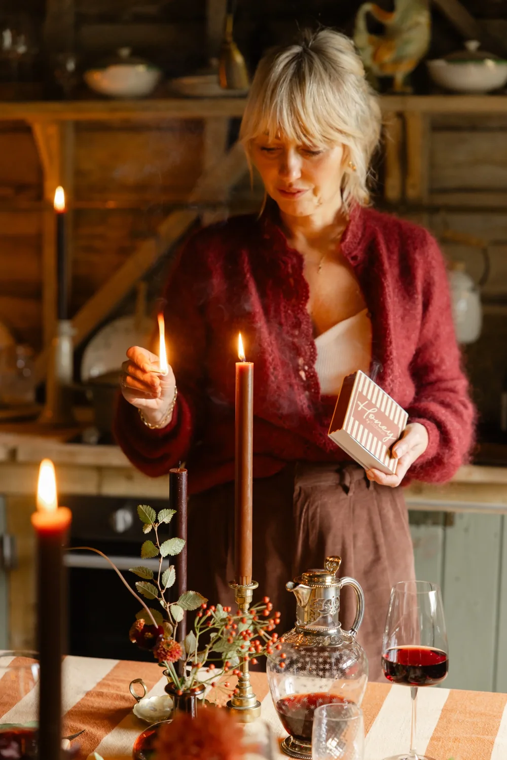 HBC Autumn Clo lighting the caramel candle.webp